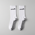 Pair of white PrimeLift non-slip gym grip socks with black sole grips